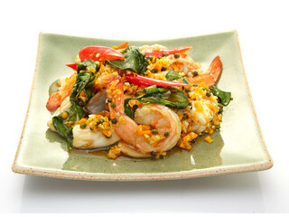 stir-fried seafood (shrimps and squid) with Thai basil Asian food style Isolated on white background.