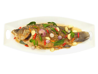 Fried fish toppted with chilli sauce Isolated on white background.