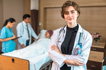 Obraz premium Young cauasian woman in medical robe smiling and looking at camera during work against at clinic.Women healthcare medical checkup concept.