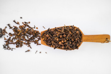 cloves on a wooden ladle-dried Indian spice.