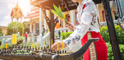 Beautiful Asian girl at big Buddhist temple dressed in traditional costume