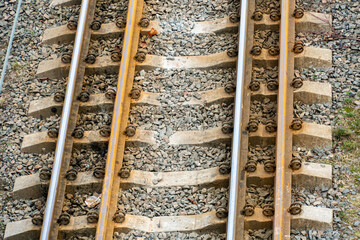Naklejka premium Railway and sleepers close-up. A major railway interchange near the station for train traffic, logistics between cities, cargo transportation.