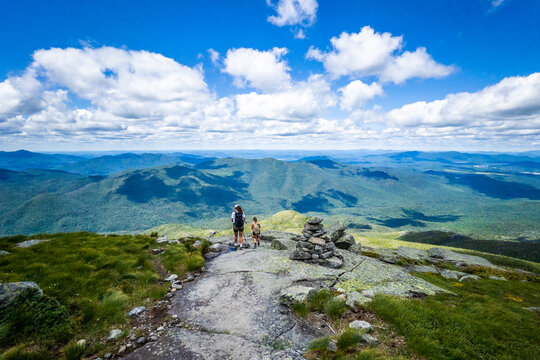 Family hikers on the top of Algonquin Peak in Adirondack mountains in Upstate New York