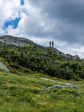 Hikers on the top of Algonquin Peak in Adirondack mountains in Upstate New York