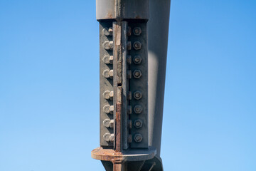 steel structure of columns with flat junction elements with bolt and nuts with oxidized elements....