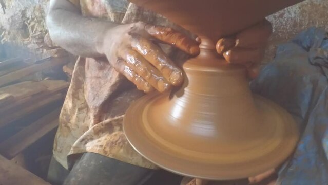 Pottery master making ceramic pot on the pottery wheel. Ceramics art concept.
