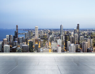 Empty concrete rooftop on the background of a beautiful blurry Chicago city skyline at evening, mock up