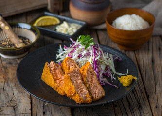 SALMON katsudon katsudon with white rice and salad served in a dish isolated on wooden background side view of japanese food