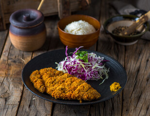 GYU HIRE katsudon with white rice and salad served in a dish isolated on wooden background side view of japanese food