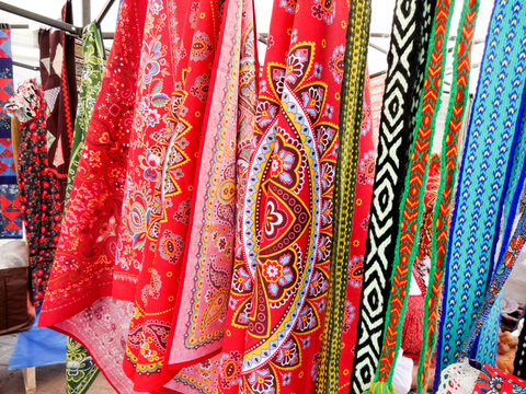 Russian folk crafts - sale of scarves at the fair of craftsmen