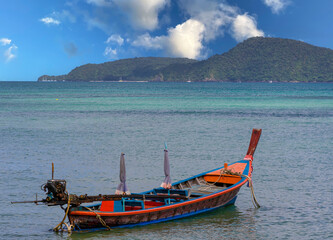Colourful Skies Sunset over Rawai Beach in Phuket island Thailand. Lovely turquoise blue waters, lush green mountains colourful skies and beautiful views of Pa Tong Patong