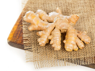 spice and condiment. Ginger root on dark wooden background top view
