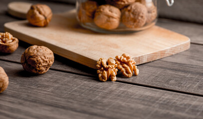 Fototapeta premium Walnuts kernels on wood desk with detail background, walnut on wood kitchen underlay.