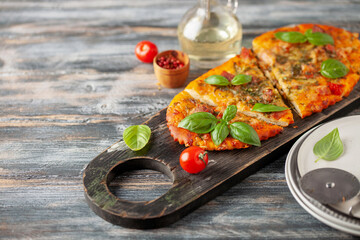Homemade pizza with tomatoes, mozzarella and basil.
