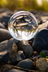 Glass ball on river rocks                                                                          ...