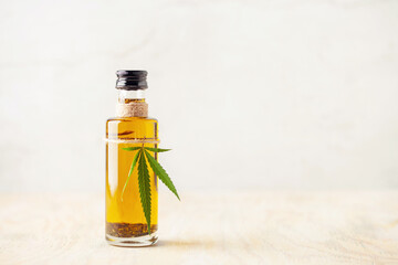 Oil and  hemp leaves and on a wooden background. Cannabis oil in a bottle. Natural eco product