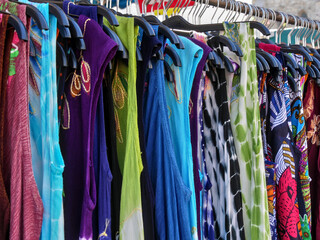Colourful clothes on sale at an outdoor market