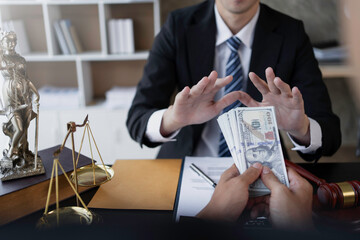Lawyer refuses to accept bribe from business people in contracting. Corruption and anti bribery concept.