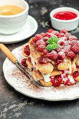Summer dessert, classic tiramisu with raspberry decorated with mint leaves. vertical image. top view