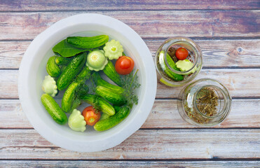 Pickling freshly picked cucumbers, tomatoes, and squash.