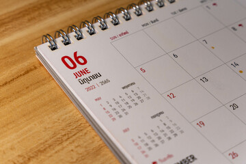 June month 2022 Calendar page on wooden background