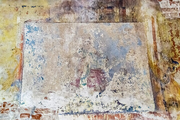 pictures on the wall of an abandoned temple