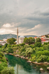 Fototapeta na wymiar View on Nerteva River and Old City of Mostar with Ottoman Mosque; Mostar in Bosnia and Herzegovina. 