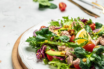 Close up tuna salad with lettuce, cherry tomatoes, avocado and red onions. superfood concept. Healthy, clean eating concept. Vegan or gluten free diet. Top view