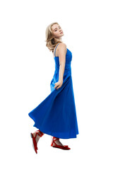 Fototapeta premium A young girl in a long blue dress. Activity, grace and movement. Full height. Isolated on white background. Vertical.