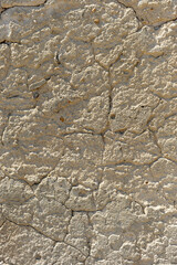 Texture of a concrete wall eroded by the action of wind and rain. Surface of an exterior wall worn and cracked by the effect of climatic agents