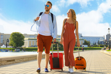 Summer holidays, tourism concept - smiling couple with luggage
