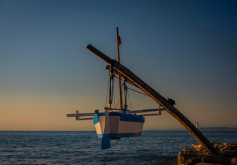 Obraz premium Boat over Jadran sea in Izola town in hot middle summer blue sky evening