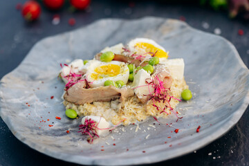Oatmeal with boiled egg, bacon and green peas. Healthy and tasty breakfast