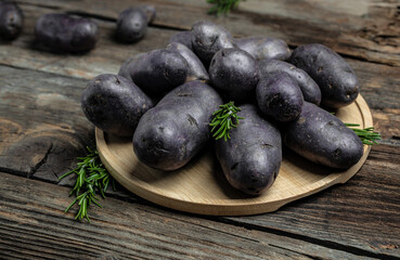 Raw purple sweet potato food . Fresh potatoes in an old sack on wooden background. Batata potato. vegan food ingredient. banner, menu, recipe place for text, top view