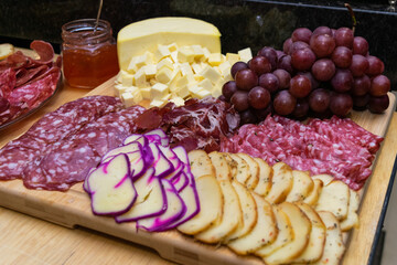 Plate of cold cuts served at the table, with fruit decoration