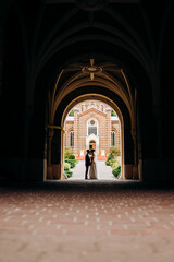 Sweet couple standing in the middle of the corridor tunnel