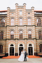 Crazy couple walking on the playground near the exclusive building