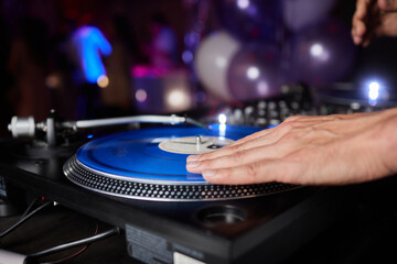 Fototapeta na wymiar DJ behind the decks in a nightclub. DJ spinning plate. people dancing in a nightclub. disco.