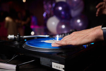 DJ behind the decks in a nightclub. DJ spinning plate. people dancing in a nightclub. disco.