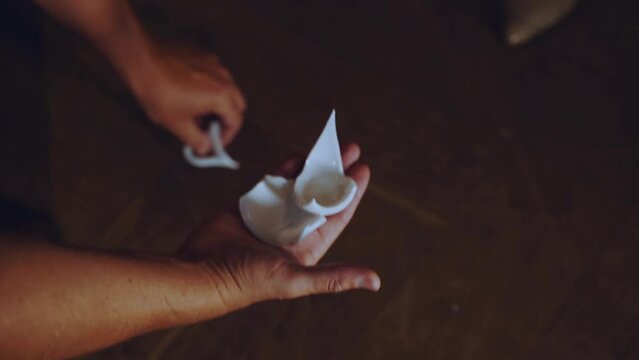 Men's hands collect the broken cup