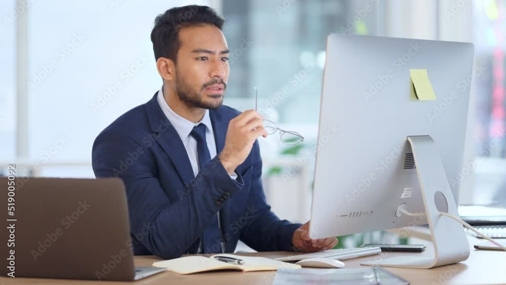 Poster Information Technology software engineer analyzing data management system. Thoughtful analyst looking for a solution. Thinking IT manager working on a desktop computer and laptop in a modern office.