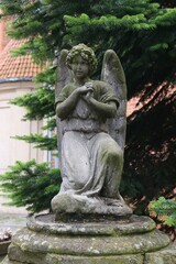 Fototapeta na wymiar figure of an angel standing next to St Mary's Church in Toruń