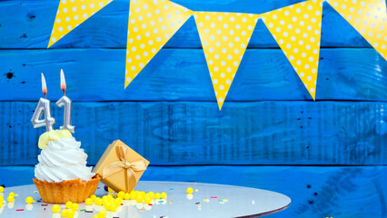 Beautiful card happy birthday with a cake with a number of candles on the background of blue...