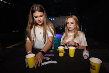 two young girls at a party. Alcohol, drugs, bad habits