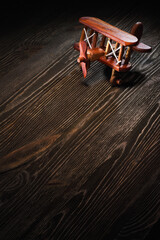 Wood toy plane on rustic wooden table.