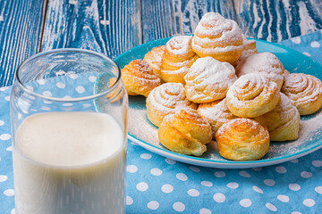 fresh backed cookies and a glass of milk on a wooden table