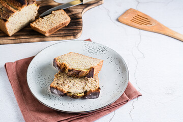Sliced banana bread on a plate on the table. Homemade trendy breakfast