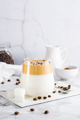 Dalgona coffee in a glass and ingredients for cooking. Social media trendy drink. Vertical view