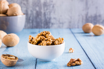 Peeled walnuts in a bowl on the table. Organic food.