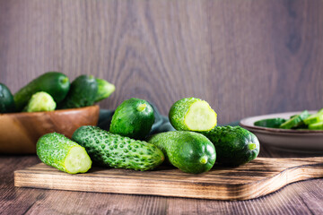 Fresh cucumbers on a cutting board on the table. Dietary organic food.